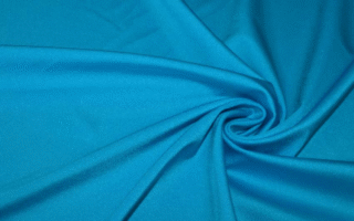 Tessuto in lycra lucida color turchese ideale per cucire un costume da bagno fai da te.